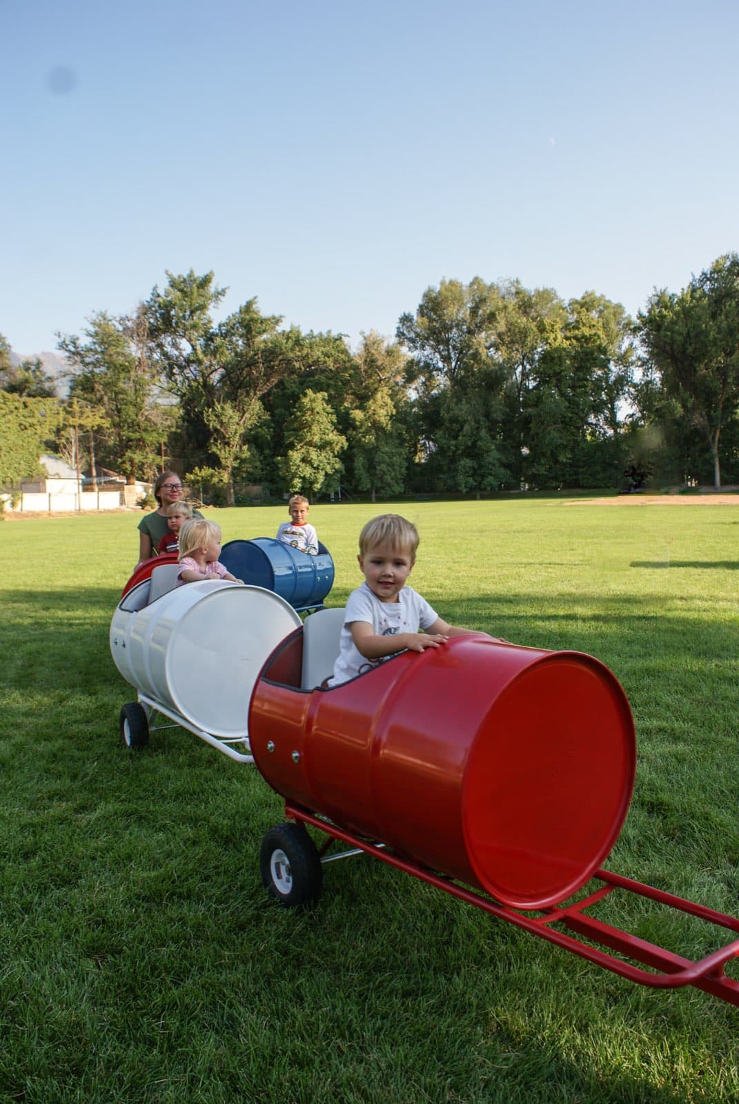 A child smiling in the barrel train