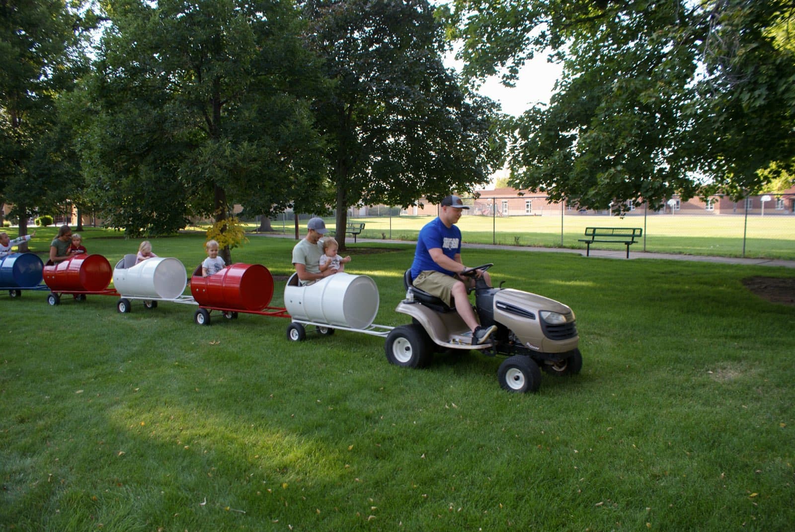 Kids riding the Backyard Barrel Express