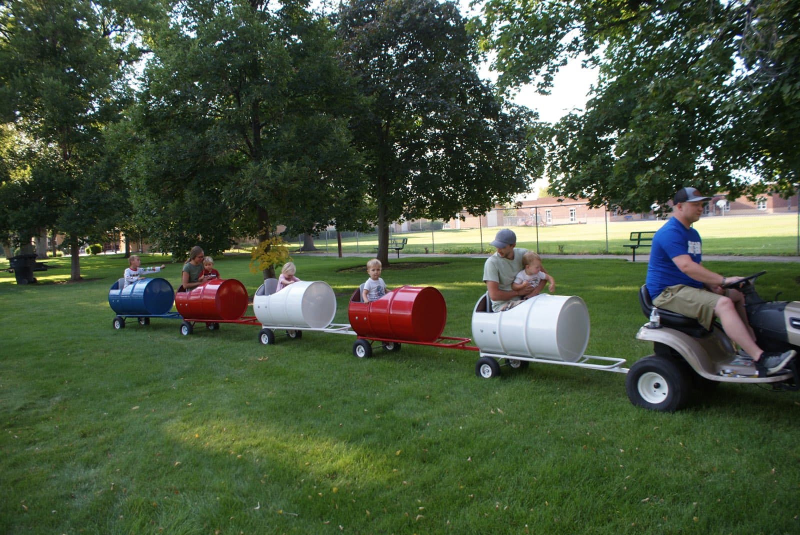 Kids riding the Backyard Barrel Express