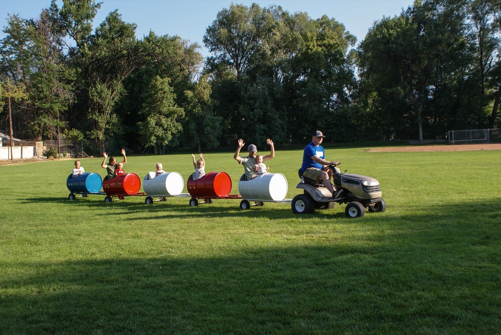 Kids riding the Backyard Barrel Express