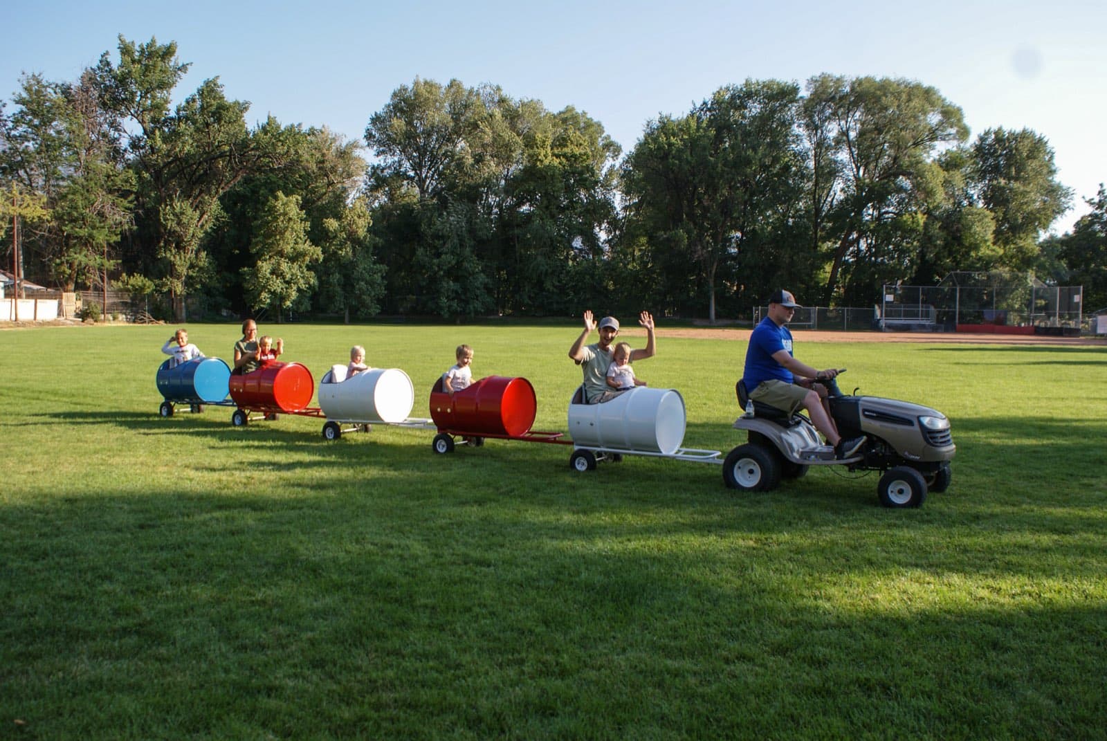 Kids riding the Backyard Barrel Express