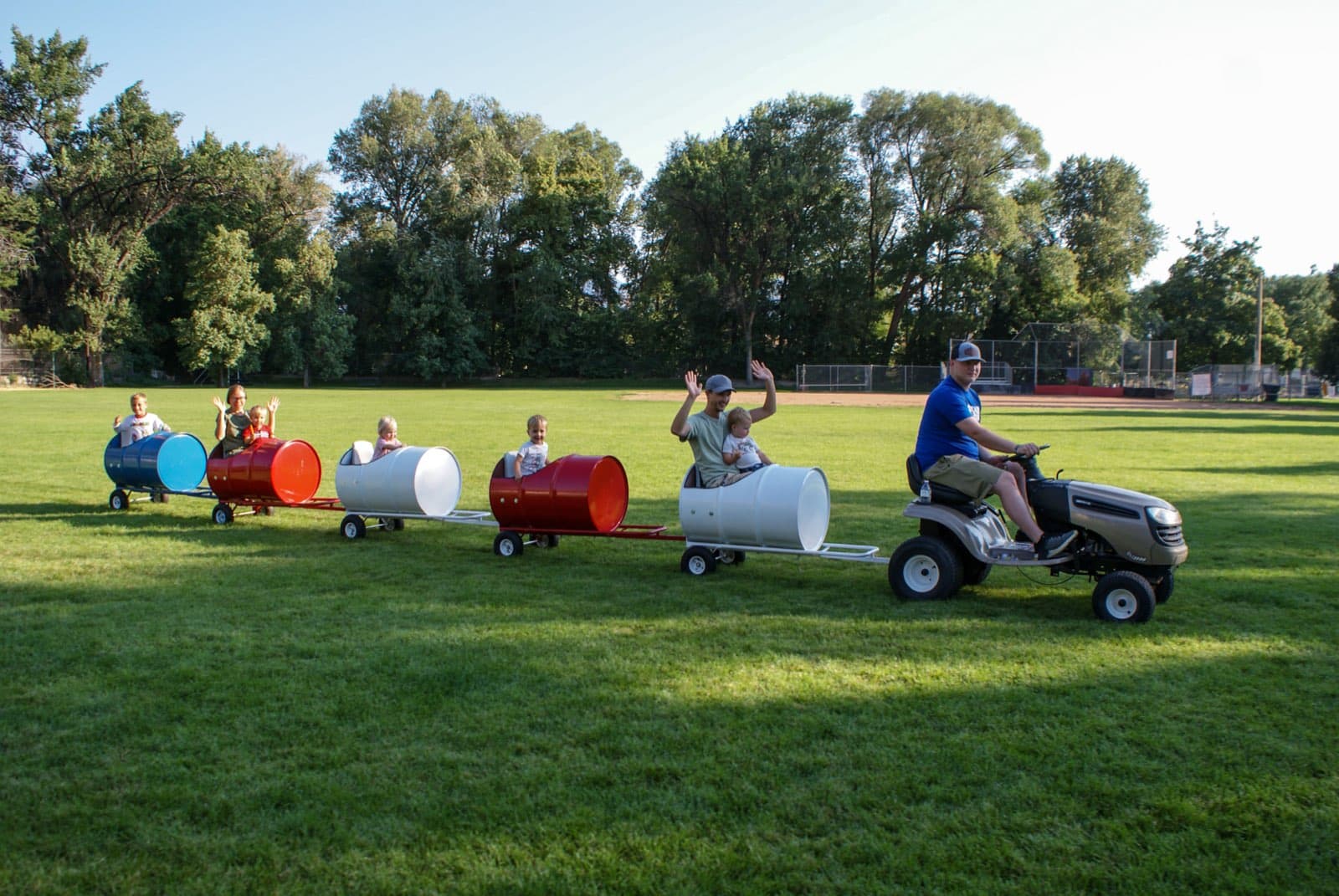 Kids riding the Backyard Barrel Express
