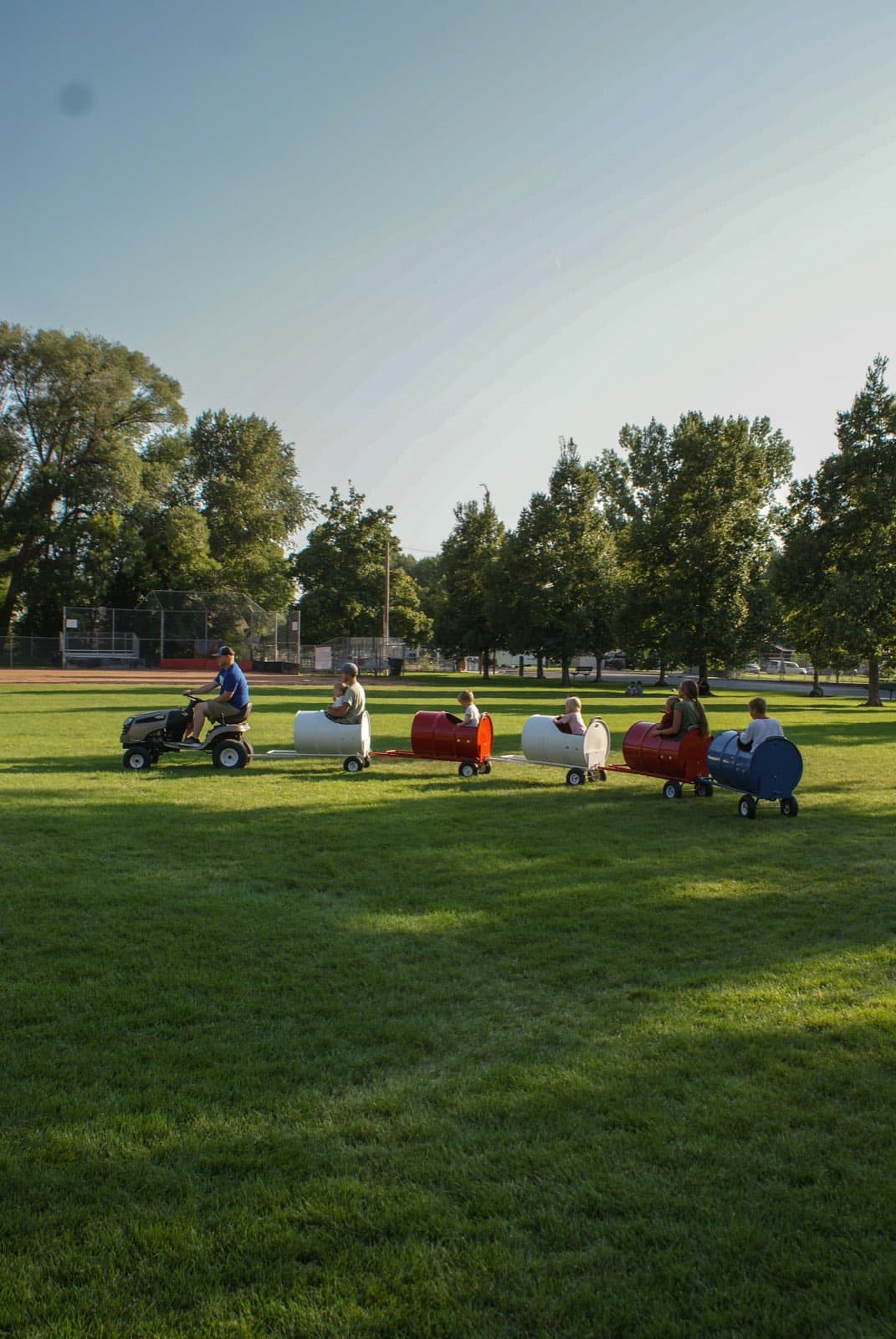 Kids riding the Backyard Barrel Express