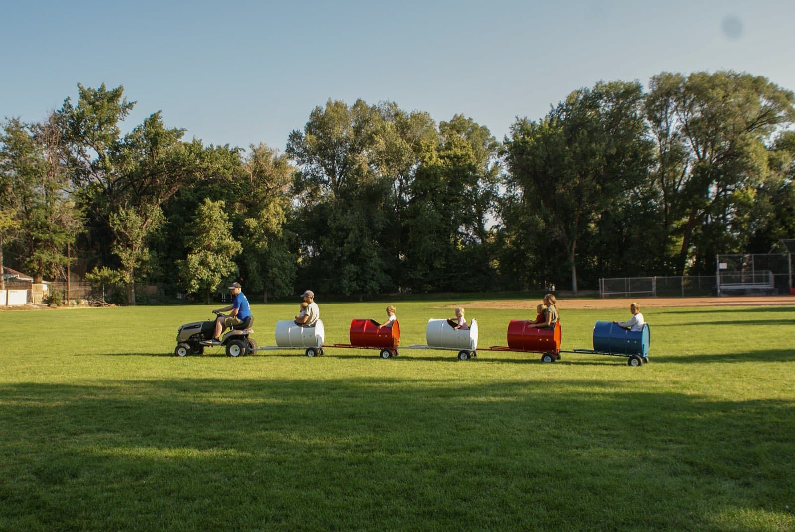 Kids riding the Backyard Barrel Express