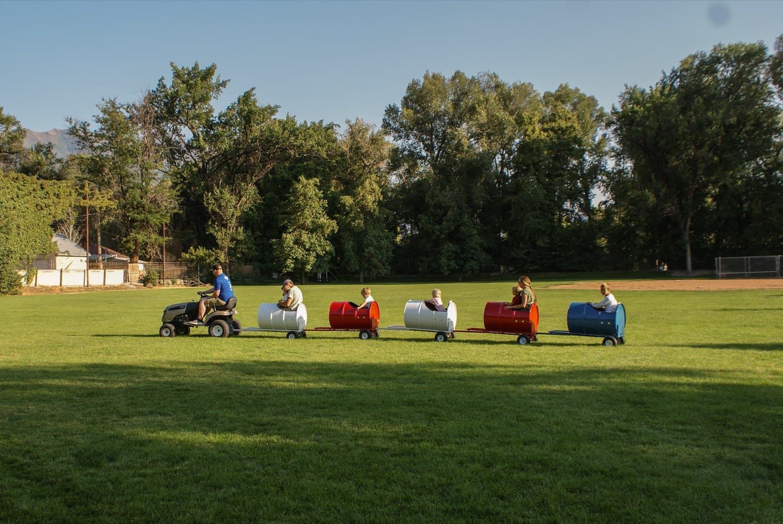 Kids riding the Backyard Barrel Express