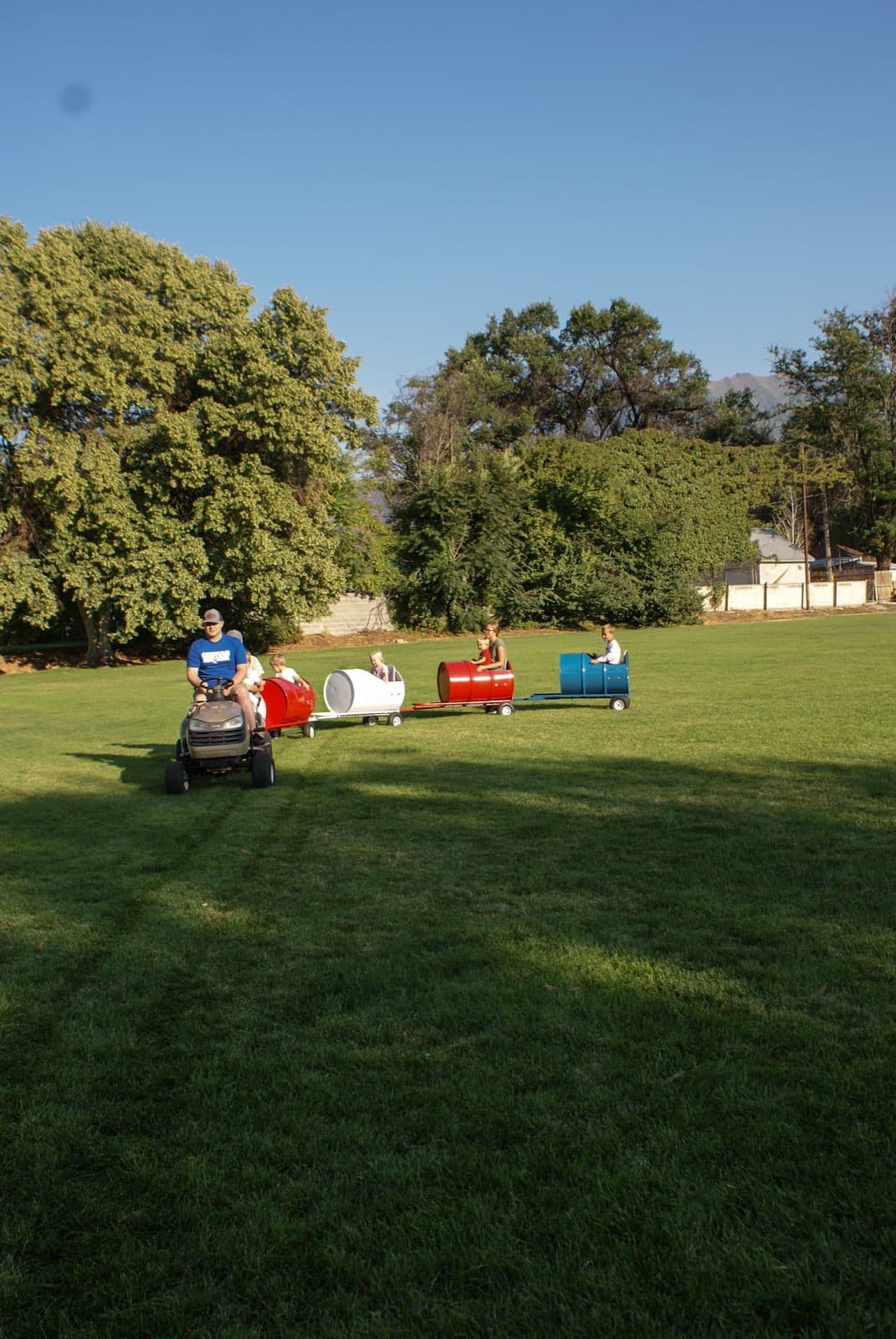 Kids riding the Backyard Barrel Express