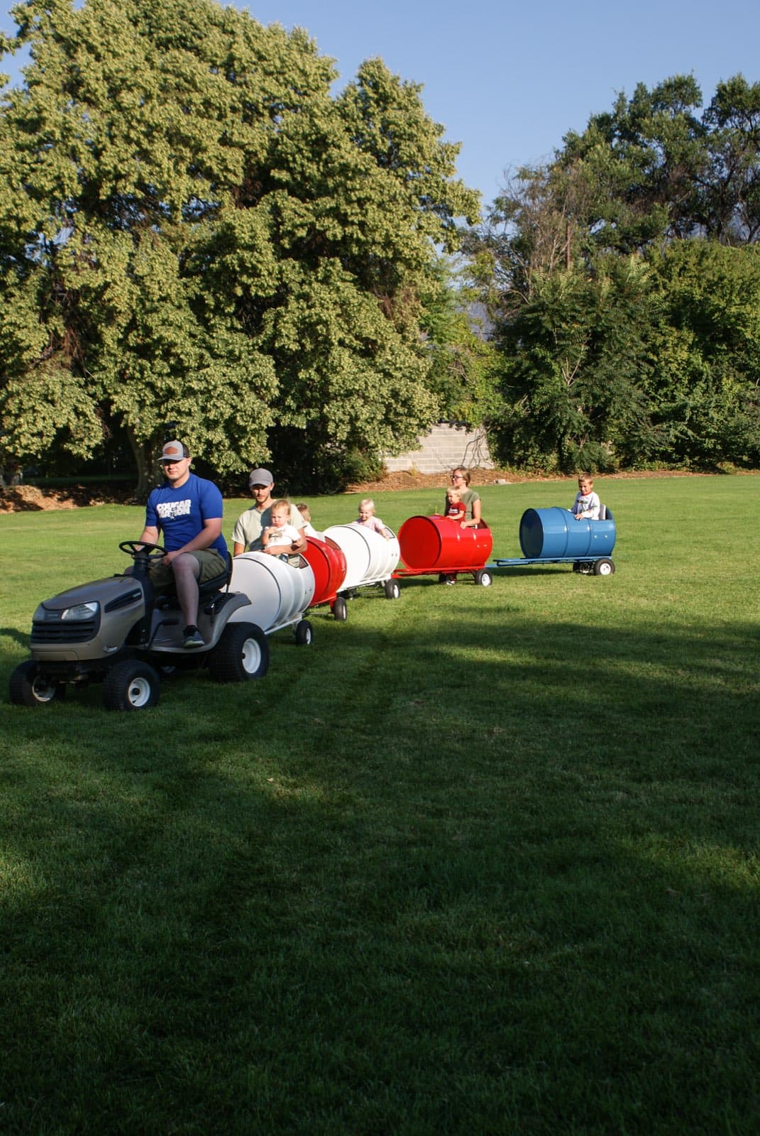 Kids riding the Backyard Barrel Express