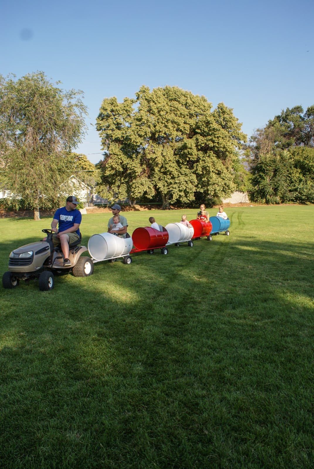 Kids riding the Backyard Barrel Express