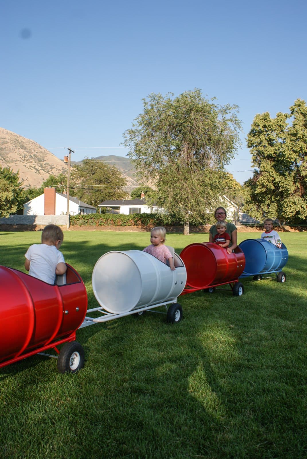 Kids riding the Backyard Barrel Express