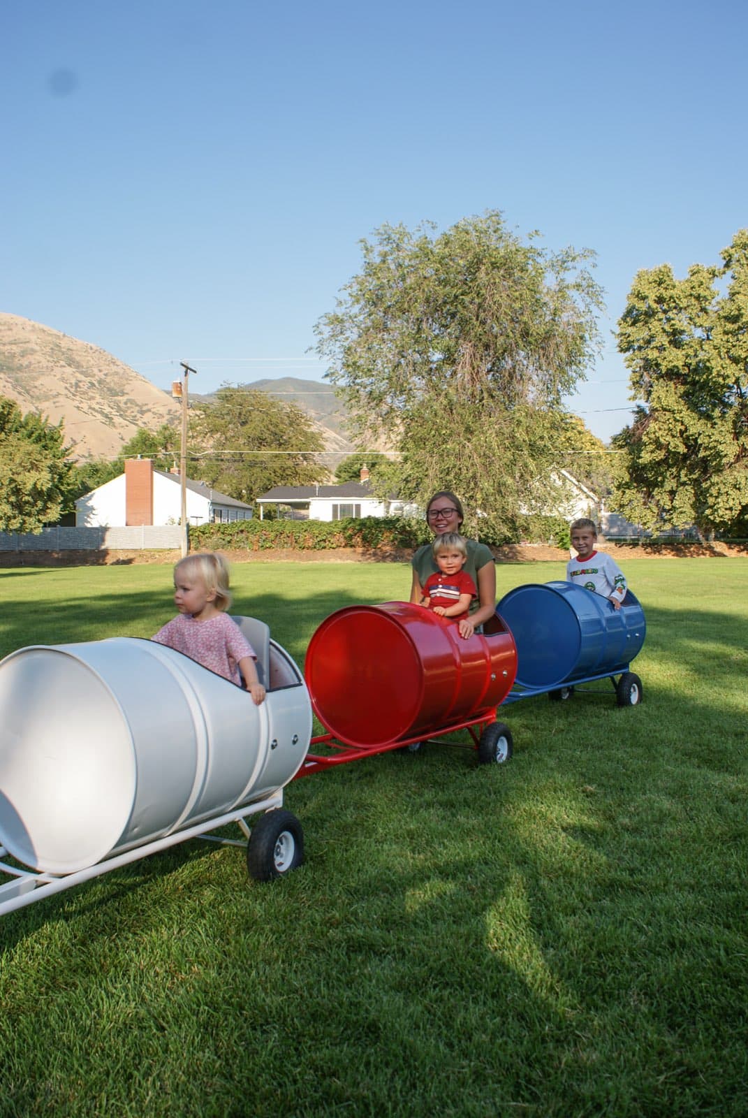 Kids riding the Backyard Barrel Express
