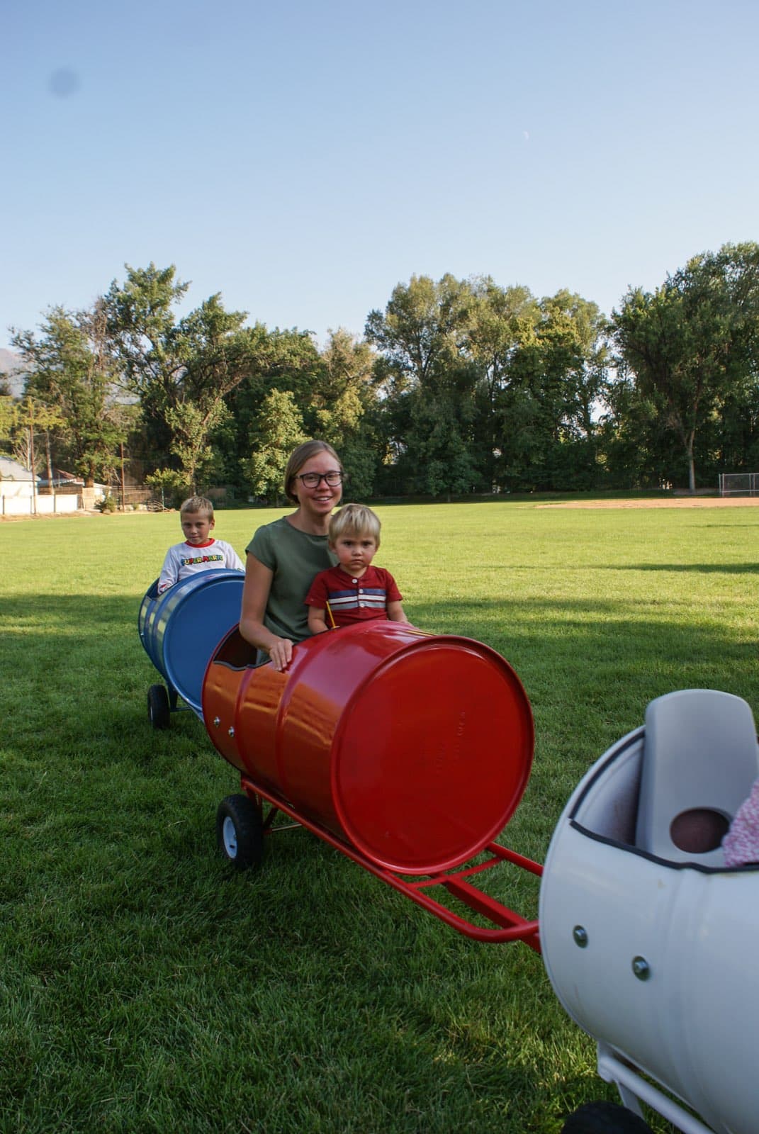 Kids riding the Backyard Barrel Express