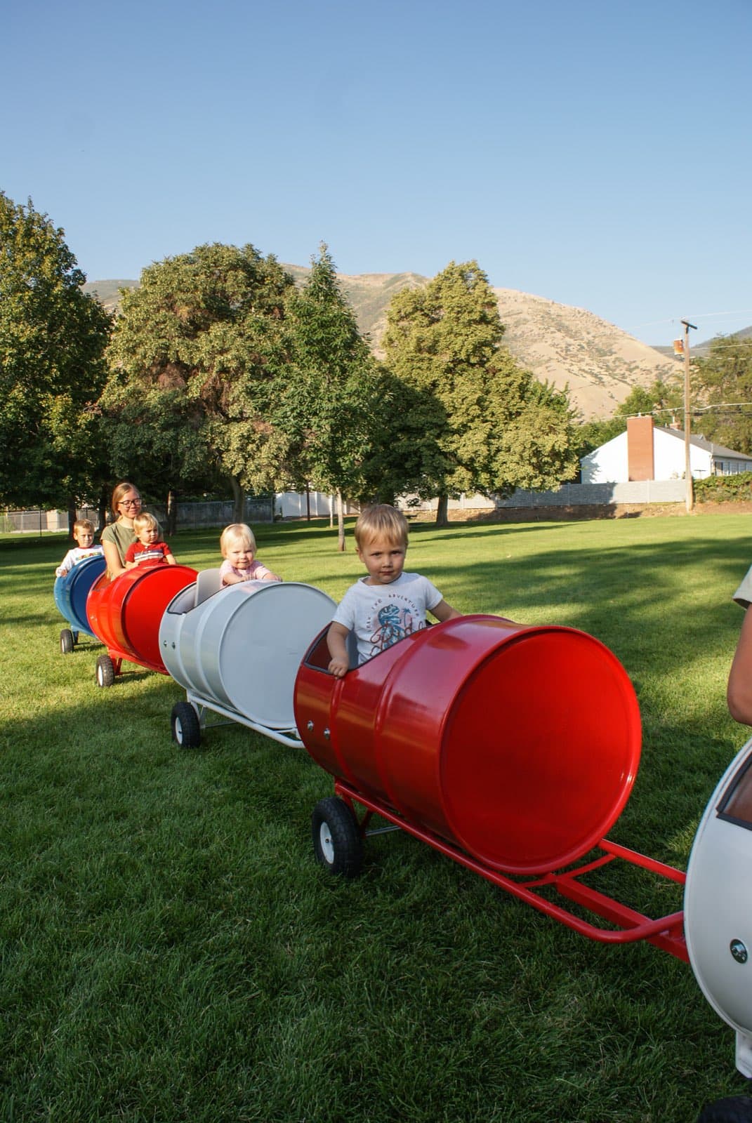 Kids riding the Backyard Barrel Express