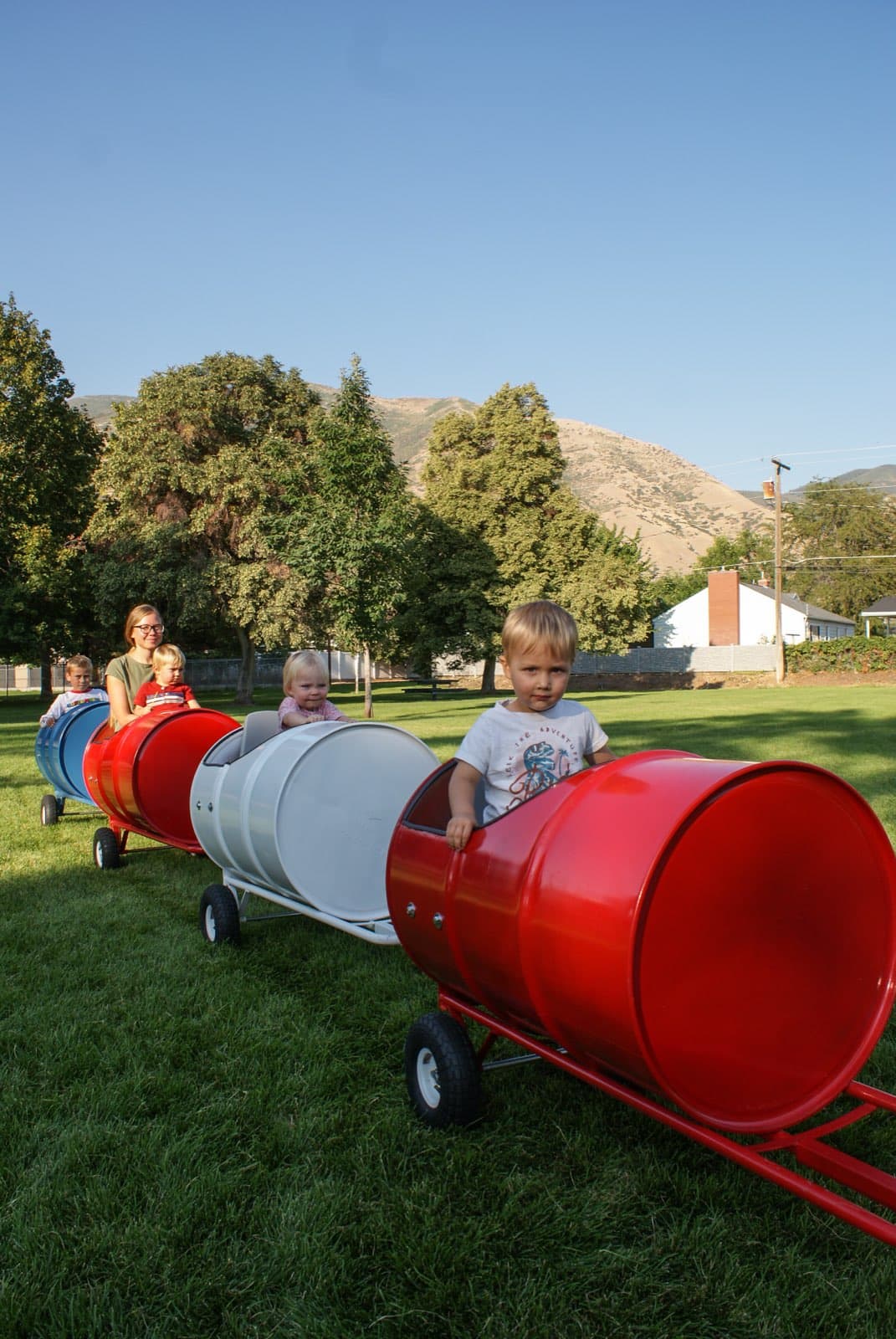 Kids riding the Backyard Barrel Express