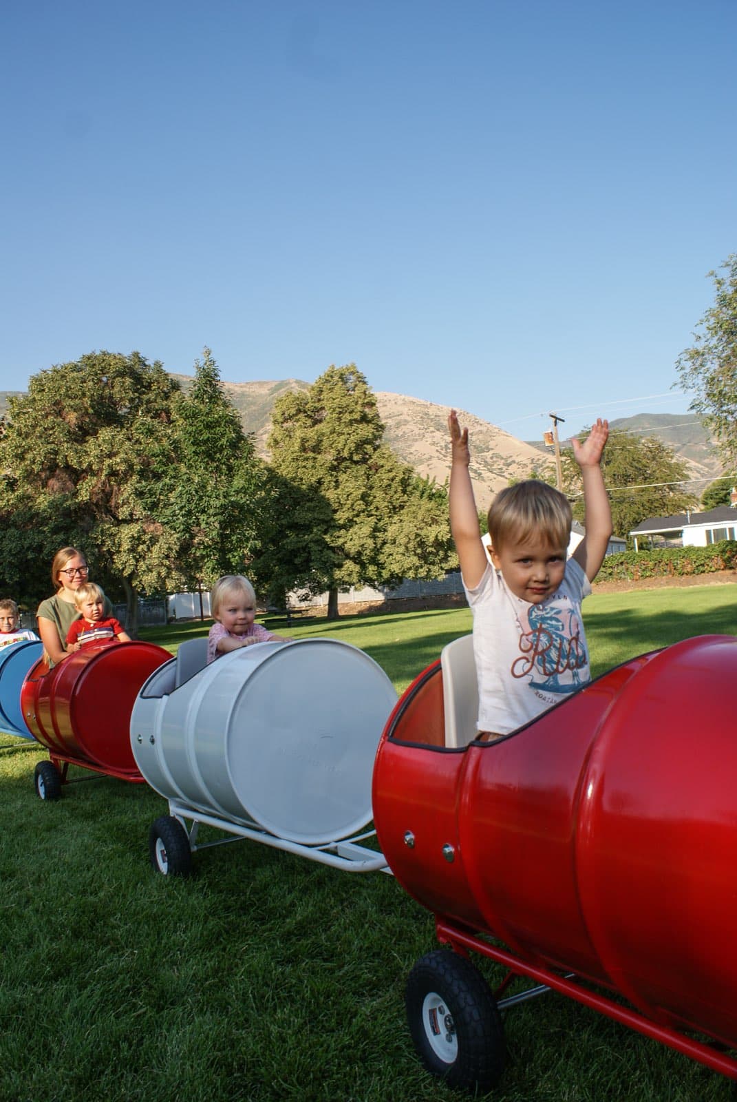 Kids riding the Backyard Barrel Express