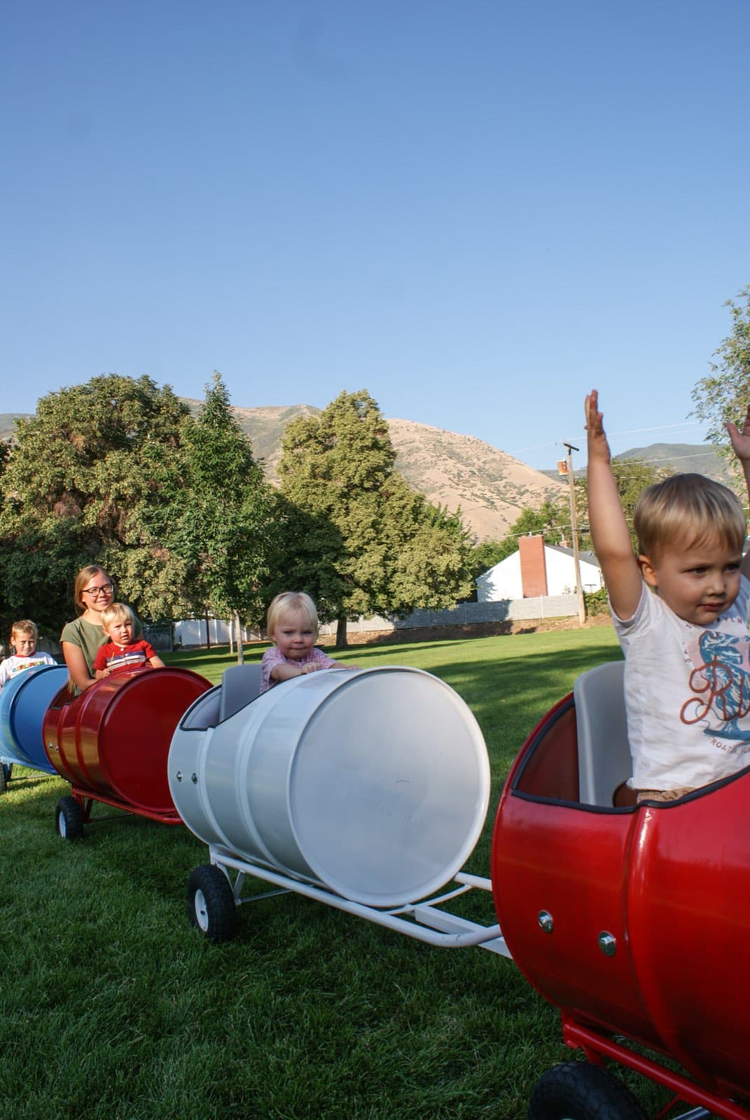 Kids riding the Backyard Barrel Express