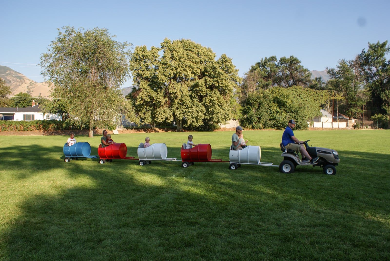 Kids riding the Backyard Barrel Express