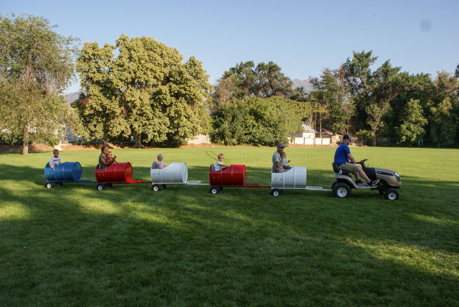 Kids riding the Backyard Barrel Express