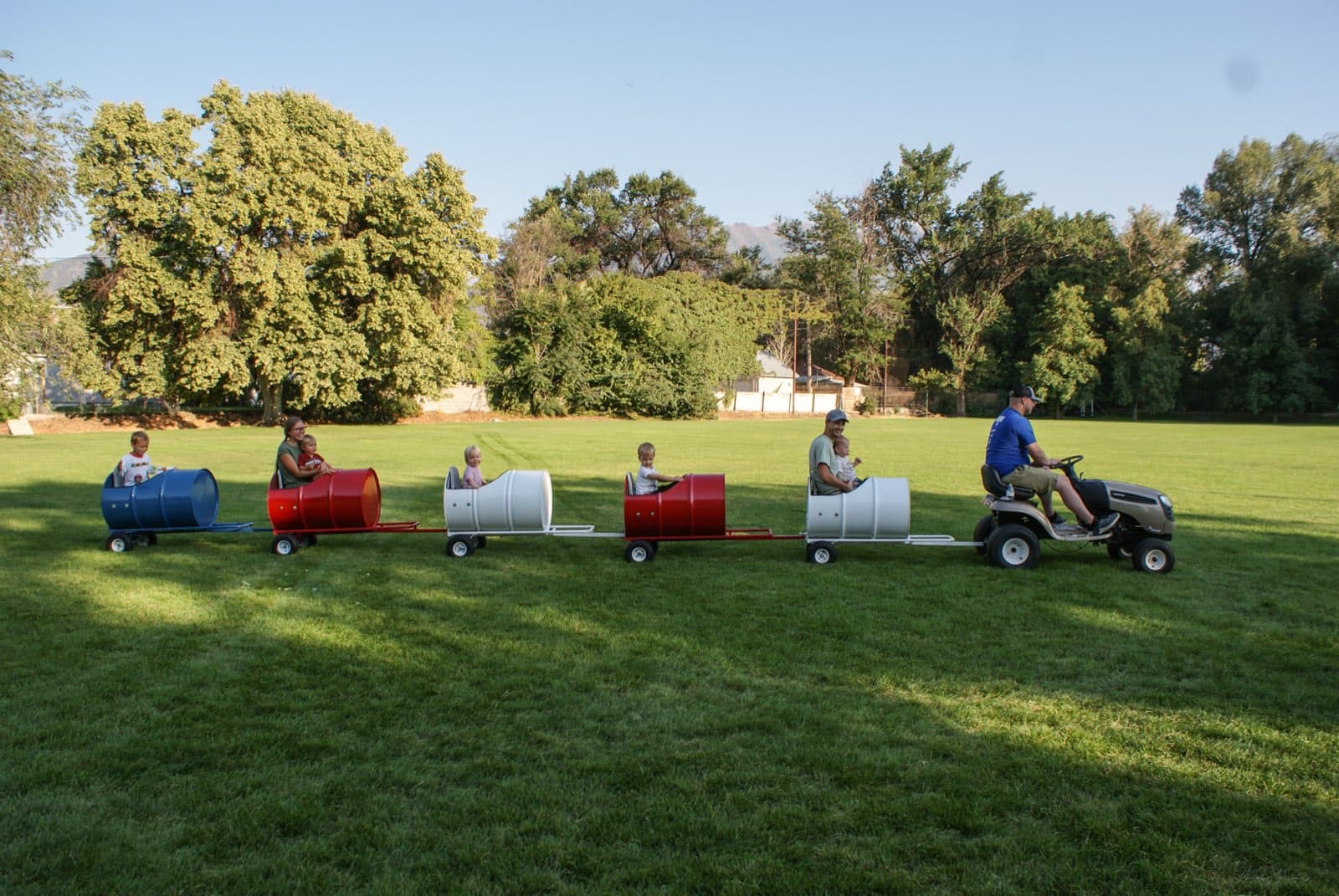 Kids riding the Backyard Barrel Express
