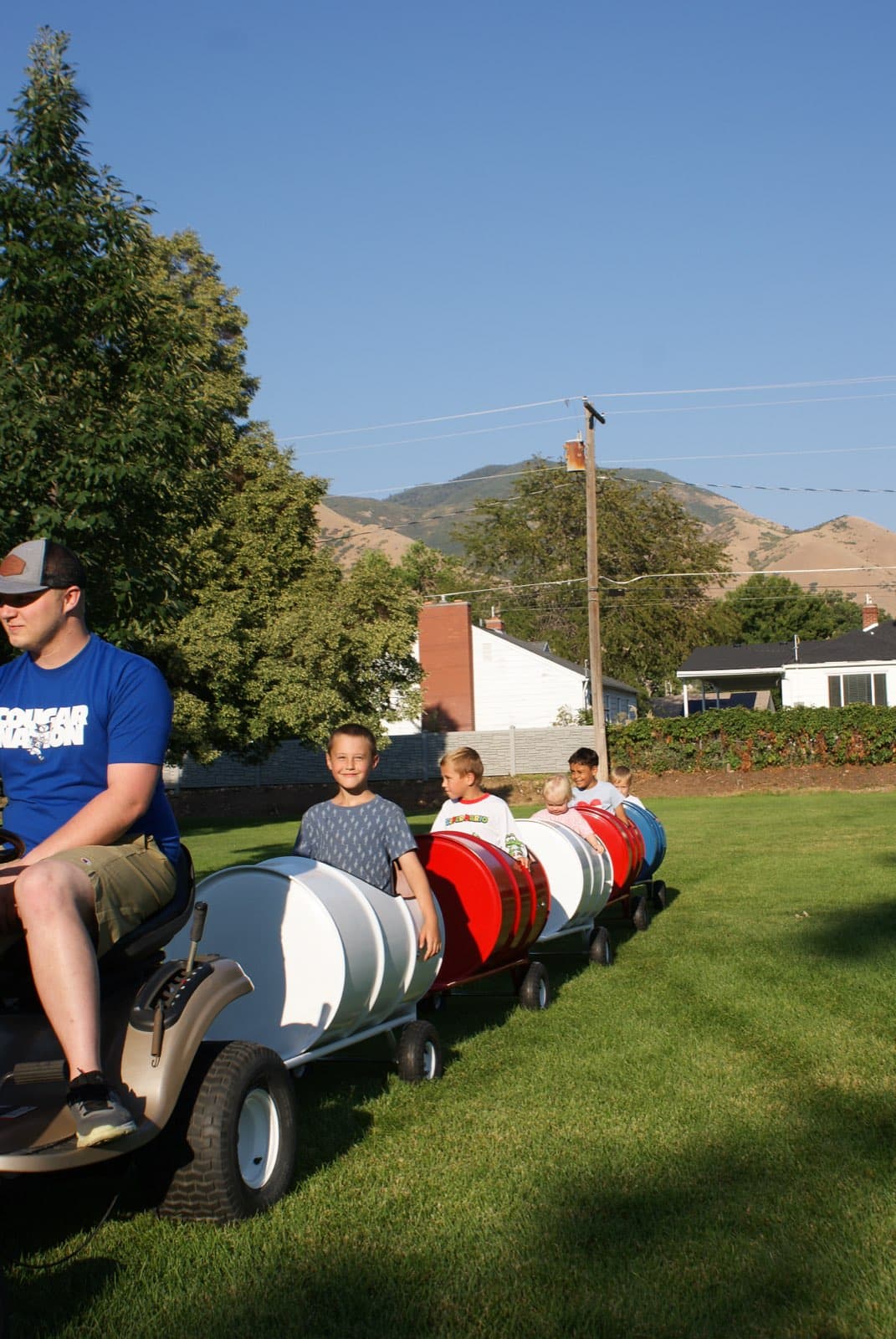 Kids riding the Backyard Barrel Express
