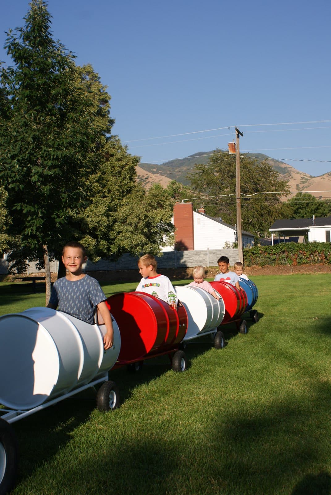 Kids riding the Backyard Barrel Express