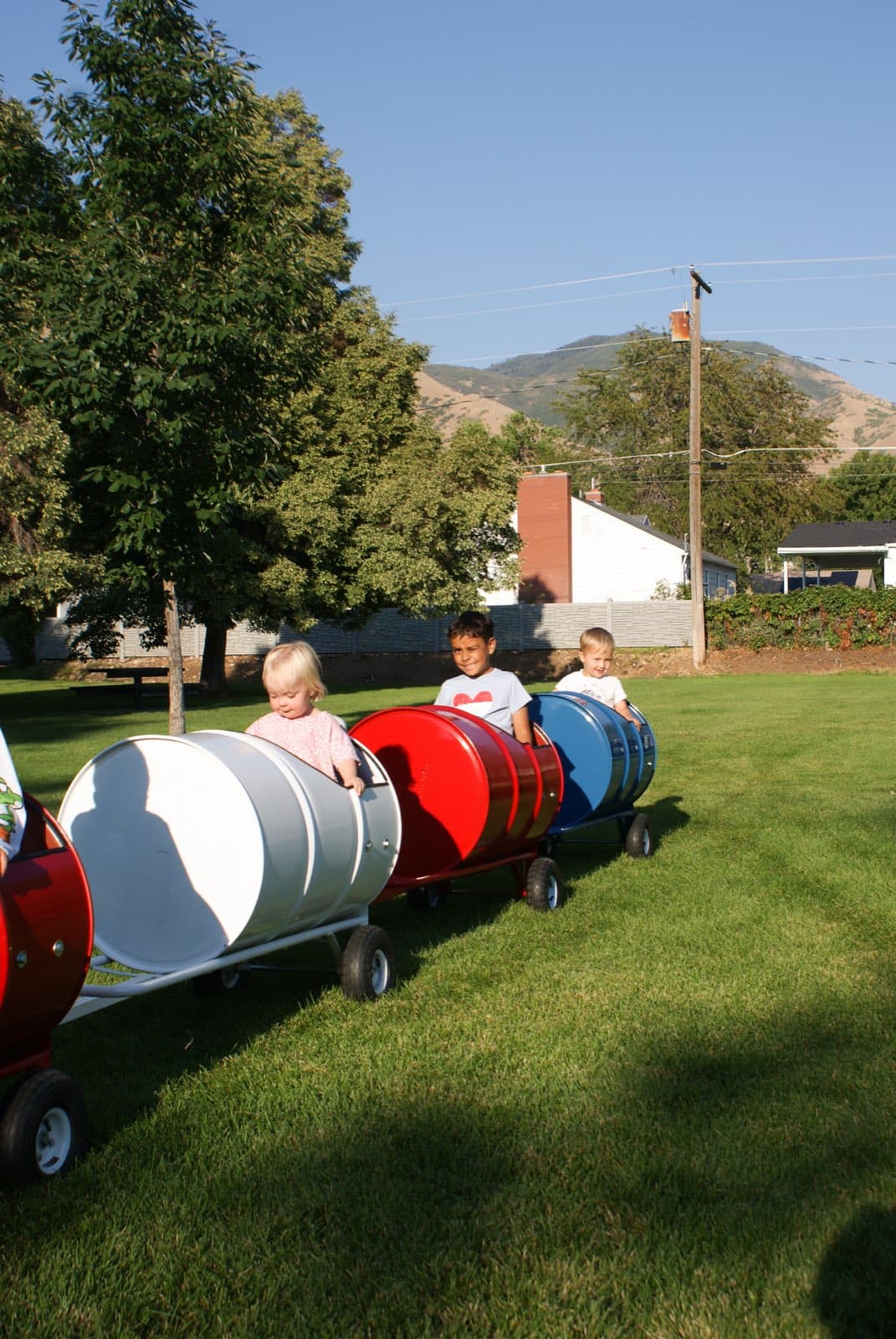Kids riding the Backyard Barrel Express