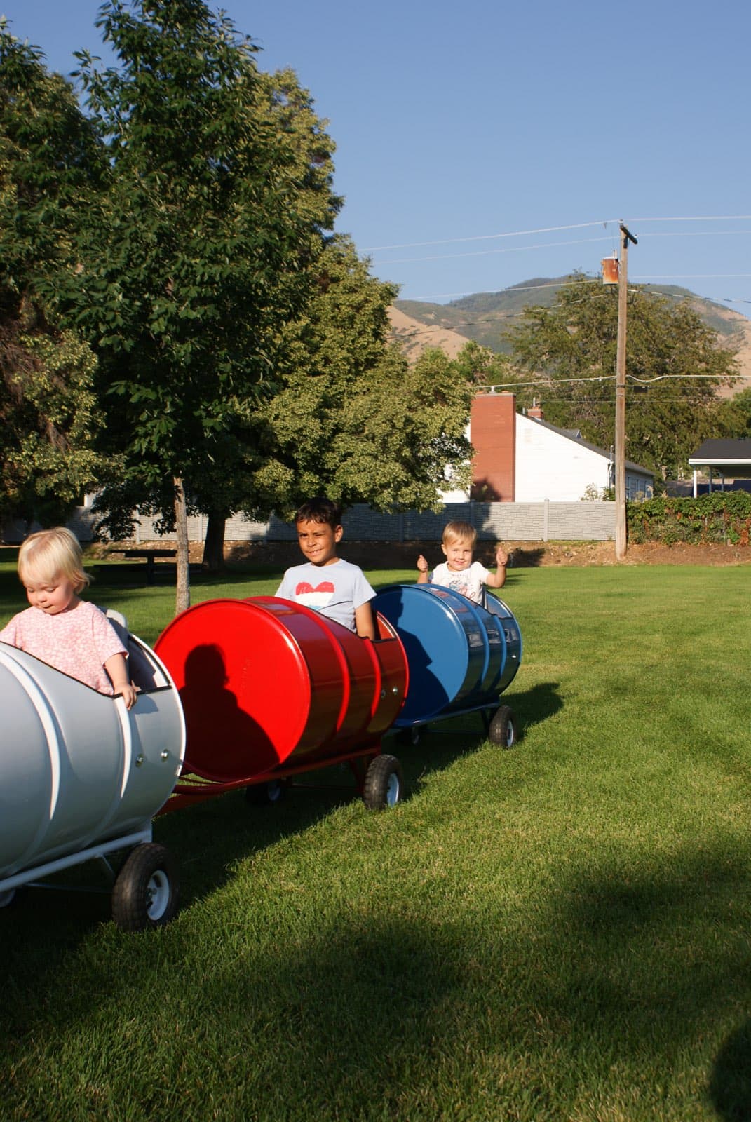 Kids riding the Backyard Barrel Express