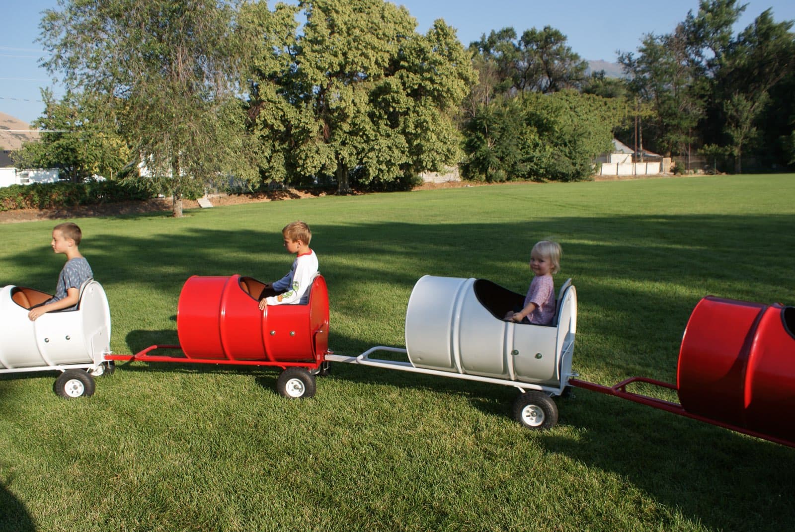 Kids riding the Backyard Barrel Express