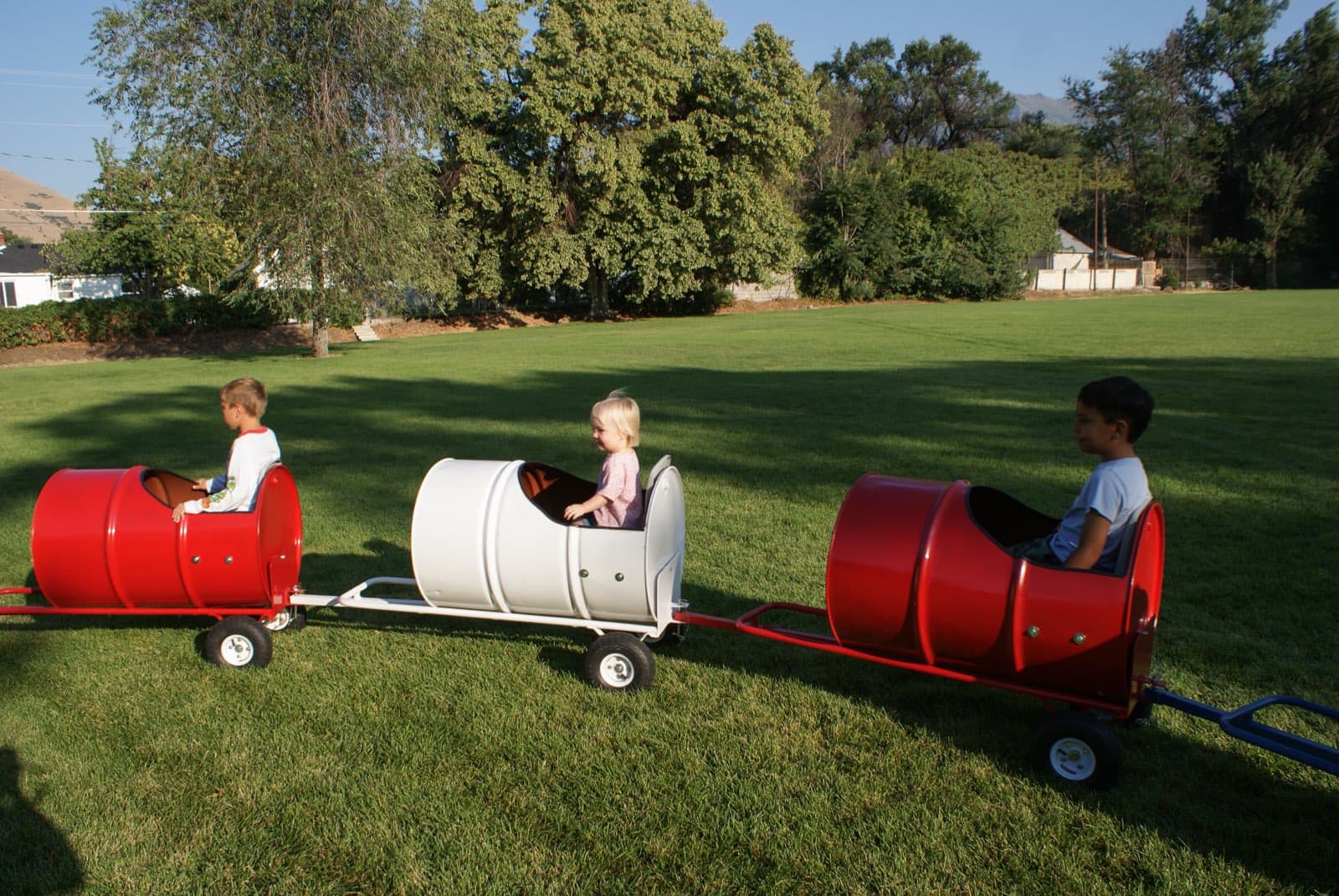 Kids riding the Backyard Barrel Express