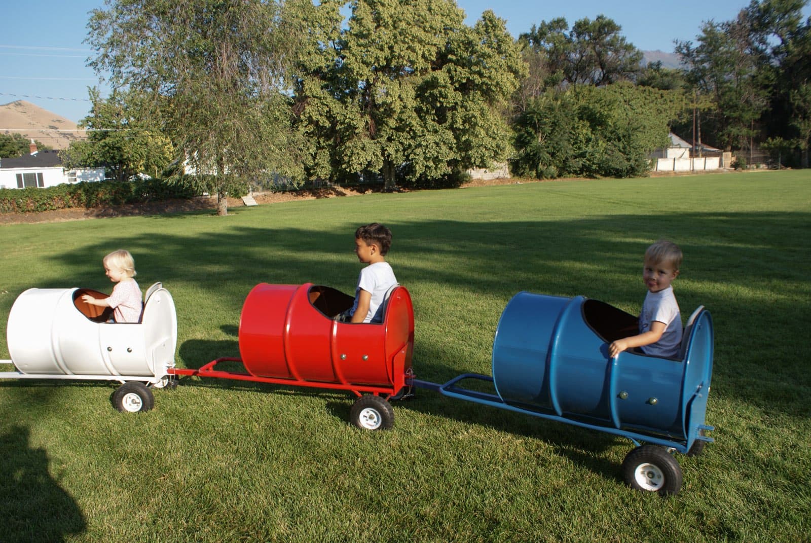 Kids riding the Backyard Barrel Express