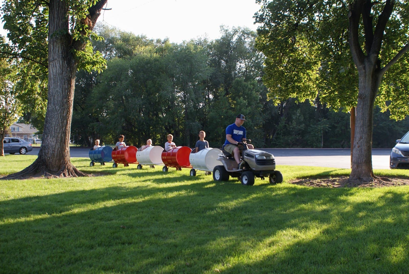 Kids riding the Backyard Barrel Express