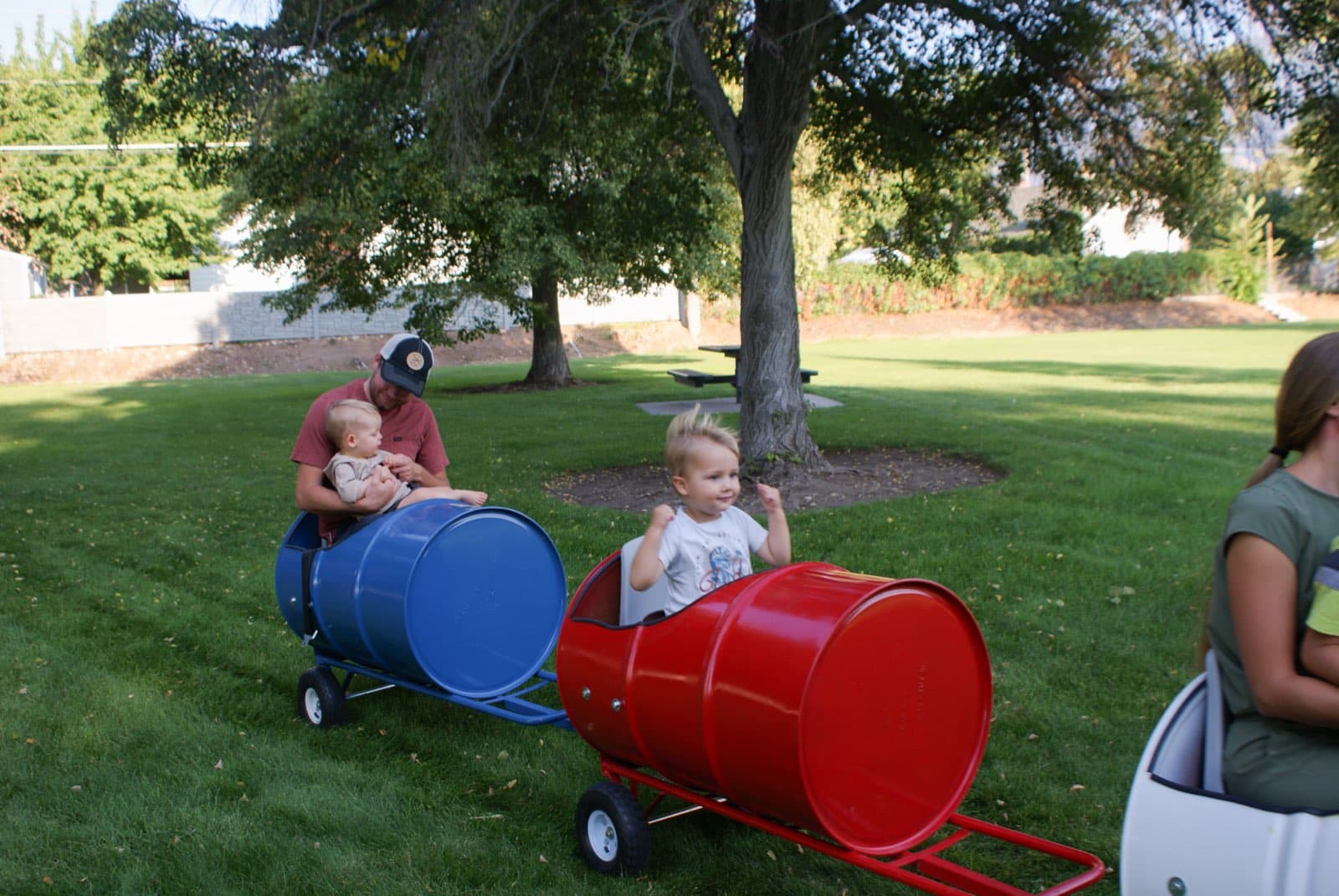 Kids riding the Backyard Barrel Express