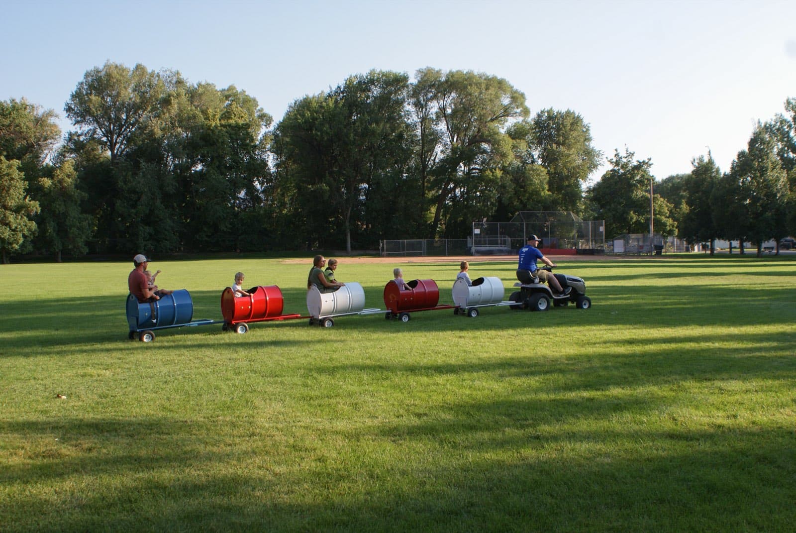 Kids riding the Backyard Barrel Express