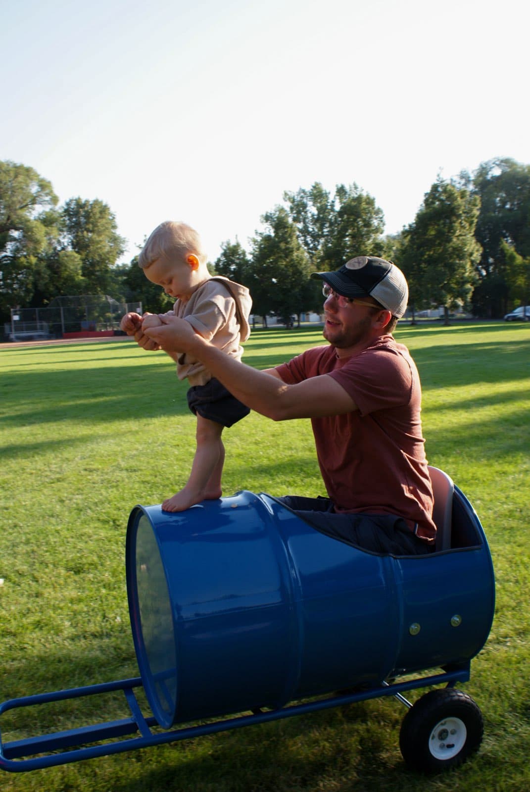 Kids riding the Backyard Barrel Express