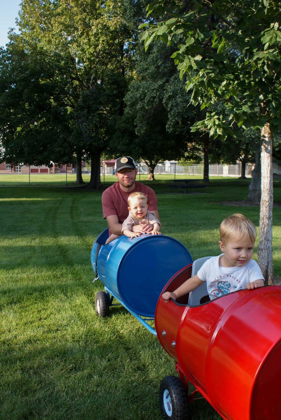 Kids riding the Backyard Barrel Express